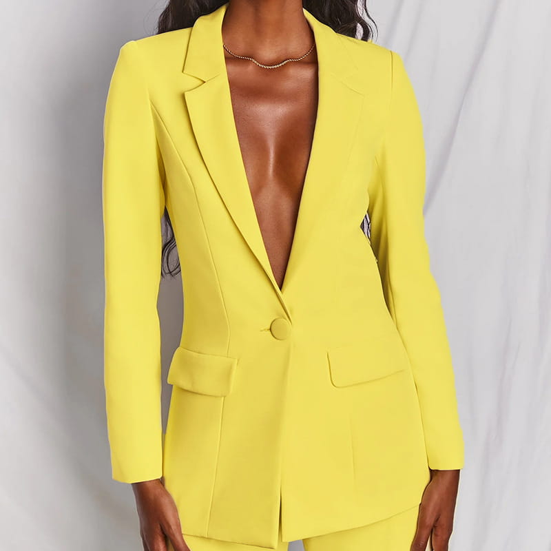 Bright yellow tailored blazer with a single button and flap pockets as part of a women’s tailored blazer and wide leg trouser suit set.