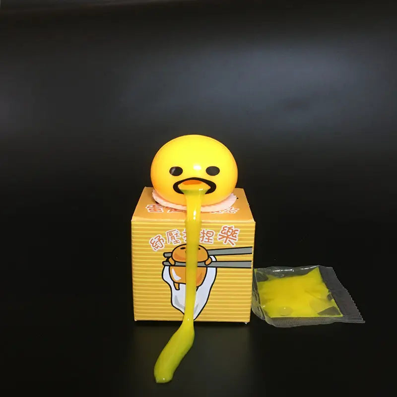 Yellow Gudetama egg-shaped stress relief toy made of soft material with a long gooey yellow slime stream extending from its mouth.