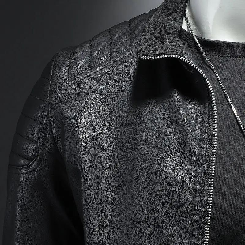 Men’s slim fit black faux leather motorcycle jacket with quilted shoulder panels and silver zipper for biker use.
