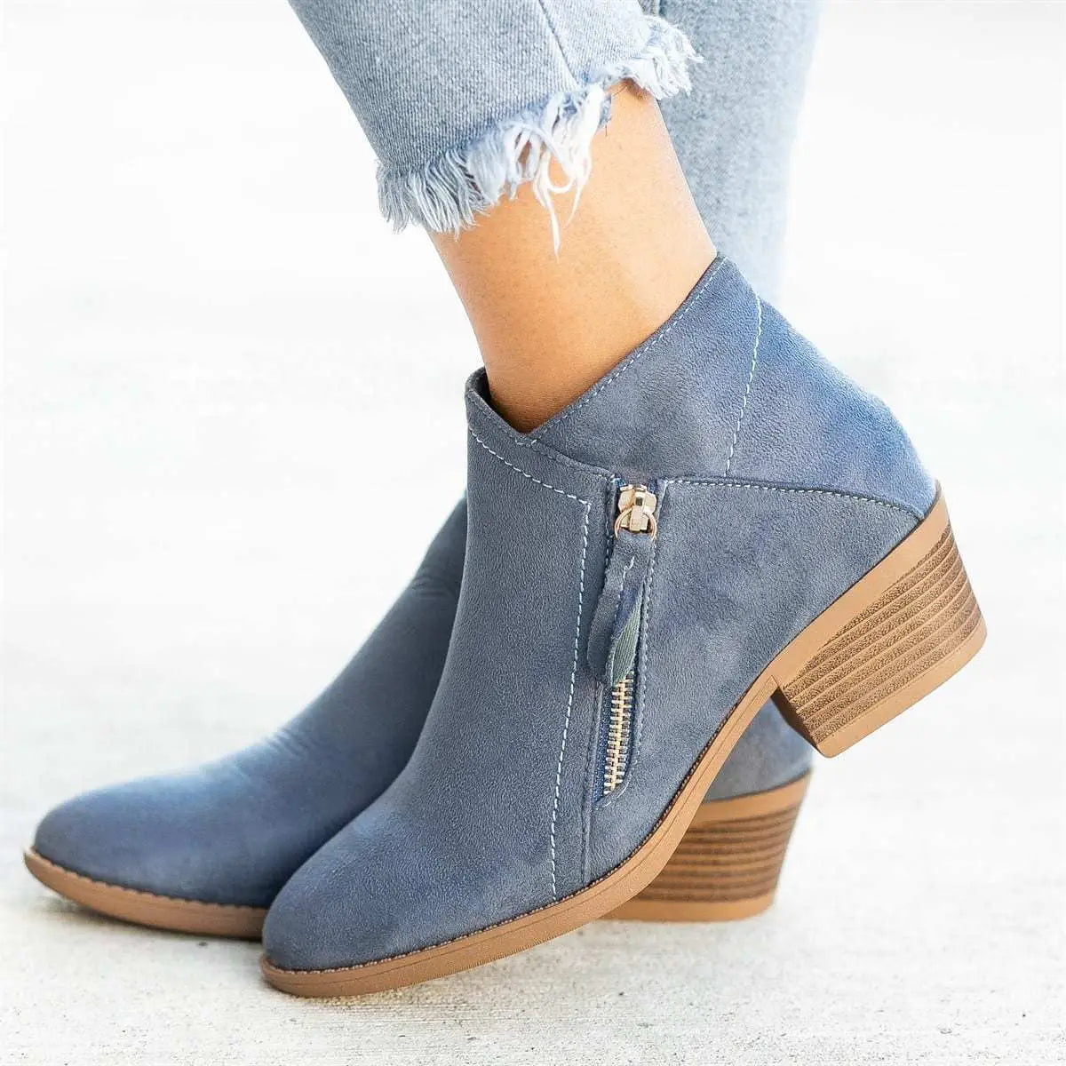 Dr Martens suede chunky heel side zip boots in blue with ankle height and stacked heel detail.