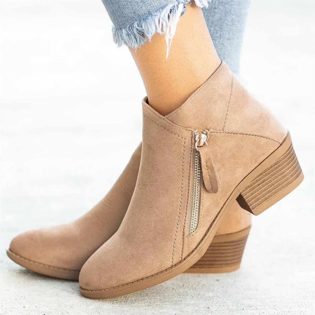 Dr Martens suede chunky heel side zip boots in tan feature a side zipper and stacked heel.