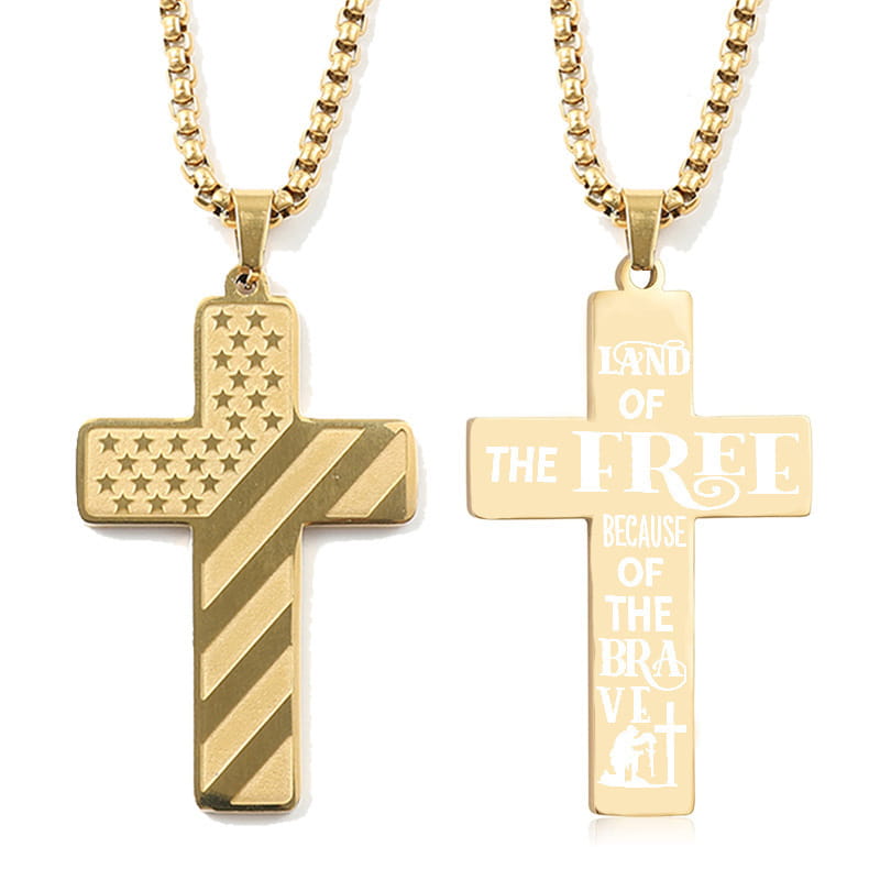 Gold-toned stainless steel American flag Bible verse cross pendant necklaces featuring an American flag design and an engraving with land of the free because of the brave.