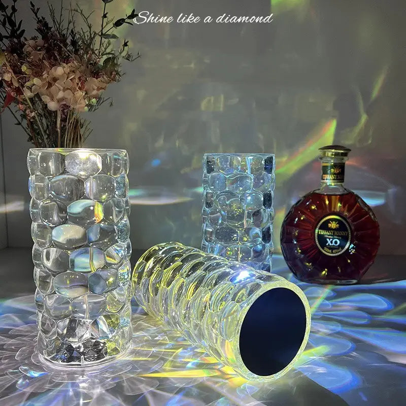 Clear glass vases with a textured bubble-like surface and one lying on its side featured in a crystal table lamp touch control diamond LED night light product display.
