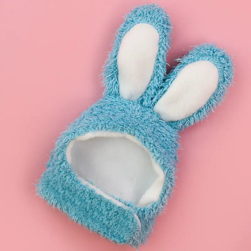 Plush bunny ear pet hat in soft light blue fuzzy fabric with white inner ears and a plush interior.