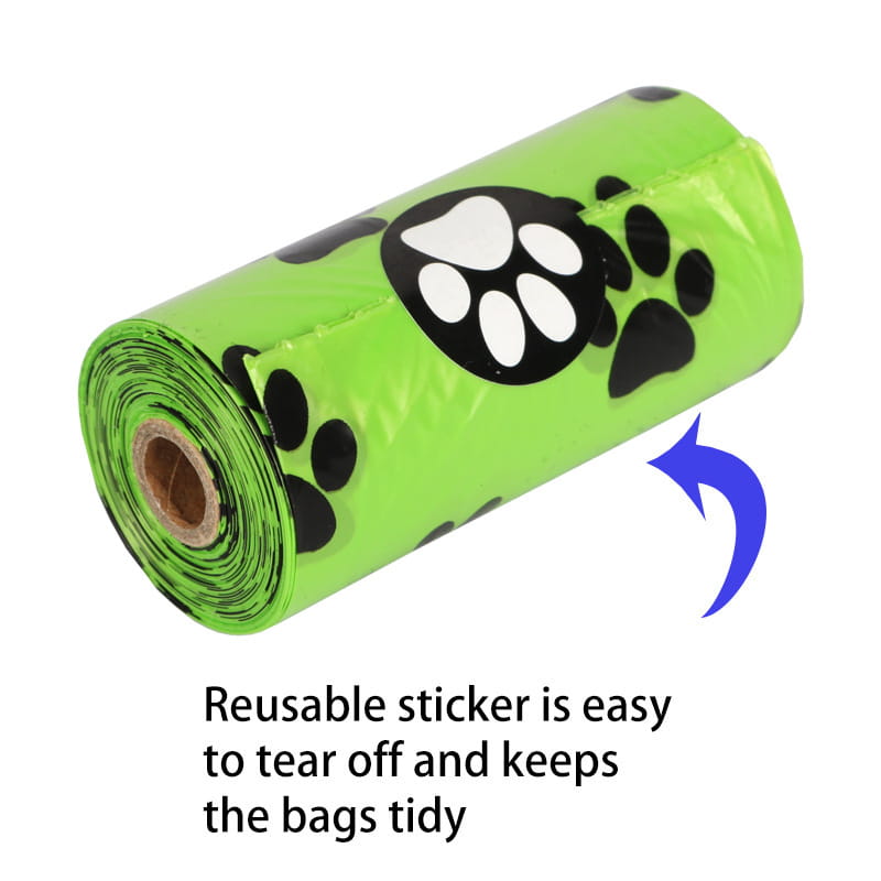 Bright green roll of plastic dog poop bags with black paw print designs featuring a dispenser and refill rolls for pet waste cleanup.
