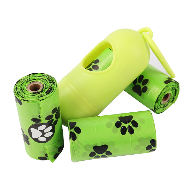 Lime green plastic dog poop bags with black paw print designs packaged in a matching lime green dispenser for convenient pet waste disposal.