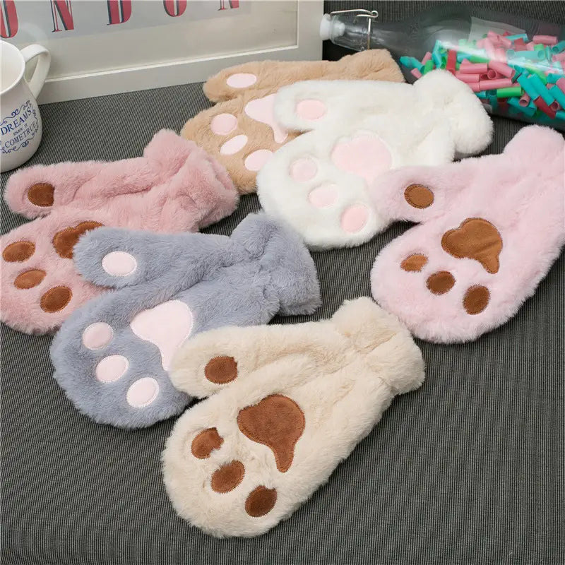 cat paw plush winter mittens made of soft plush material in pastel pink white beige and lavender with brown and light pink embroidered paw pads for warm winter use