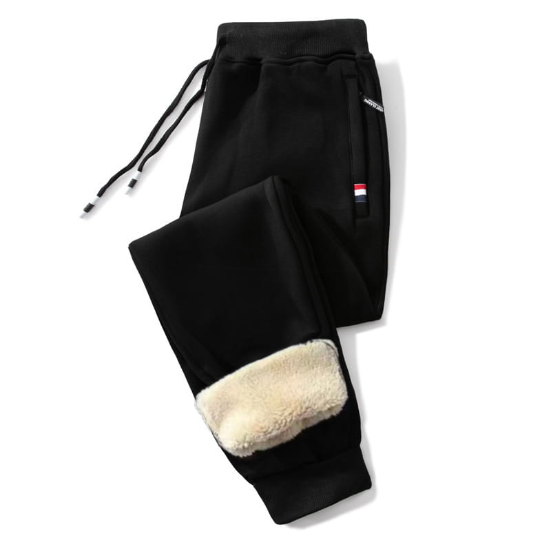 Black fleece lined mens winter jogger pants featuring plush cream colored cuffs and a small flag patch on the side pocket.