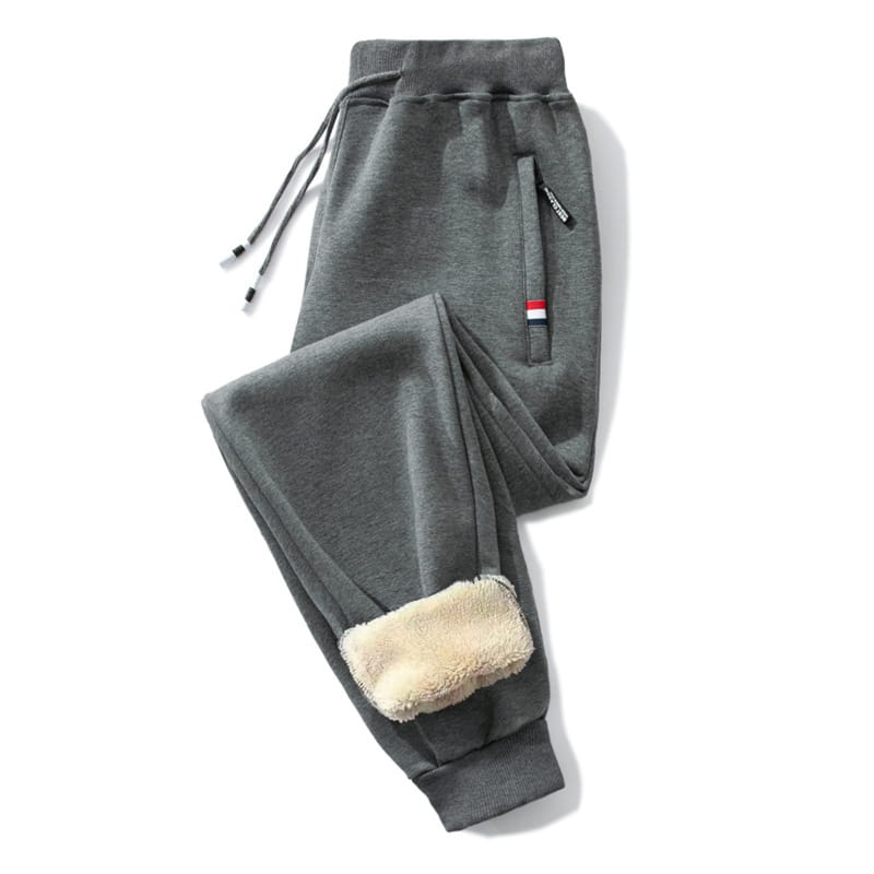 Gray fleece lined mens winter jogger pants featuring a soft textured exterior and plush beige fleece interior lining at the cuffs.
