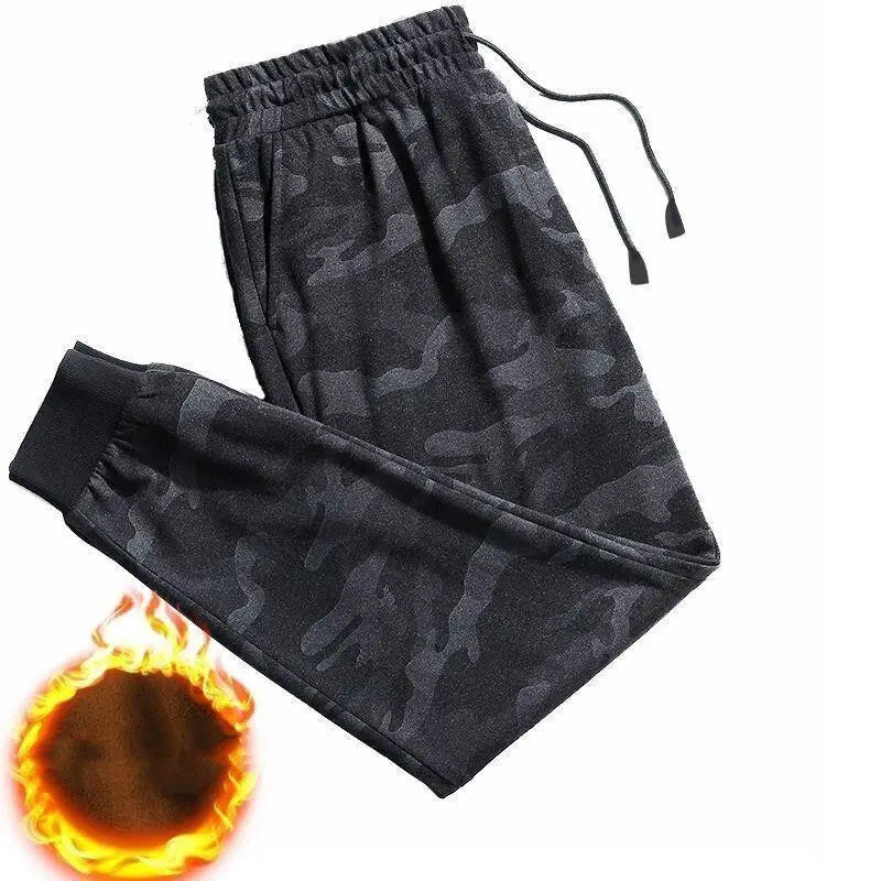 Black camouflage patterned fleece lined mens winter jogger pants with elastic waistband and drawstrings designed for warmth and comfort.