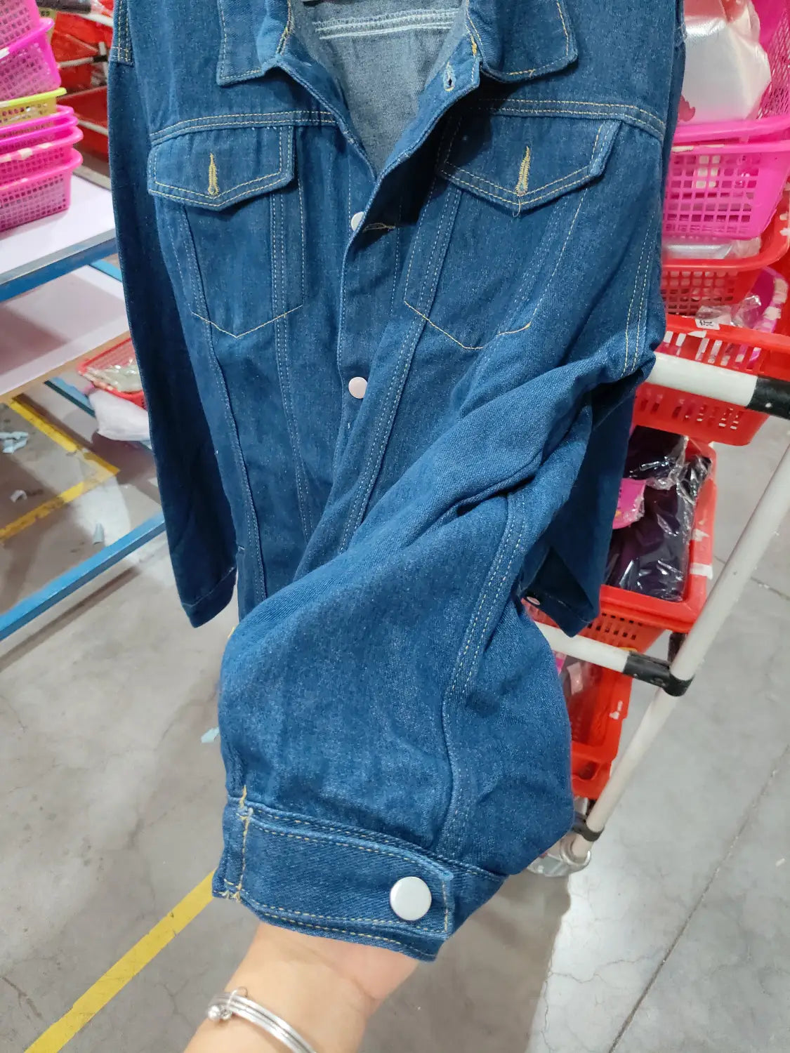 Men light wash slim fit denim jacket in classic blue with buttoned cuffs and chest pockets made from durable denim material.