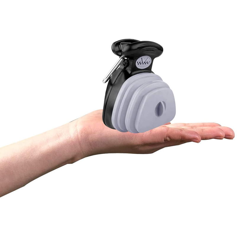 Black and gray collapsible dog poop bag dispenser with clip-on handle and waste scooper for easy pet waste management.