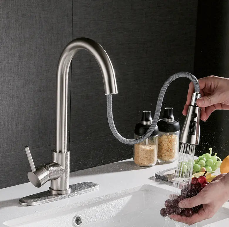 Brushed copper pull out kitchen faucet made of stainless steel with a sleek curved spout and flexible hose.