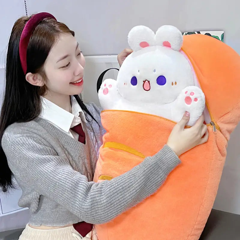 A plush animal pillow radish rabbit featuring a white plush bunny with blue eyes and pink paw pads wrapped in an orange fabric carrier.