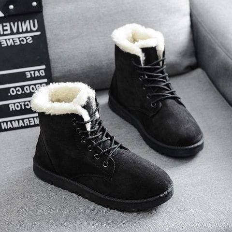 black suede martin boots for women with plush white fur lining and black laces designed as winter shoes