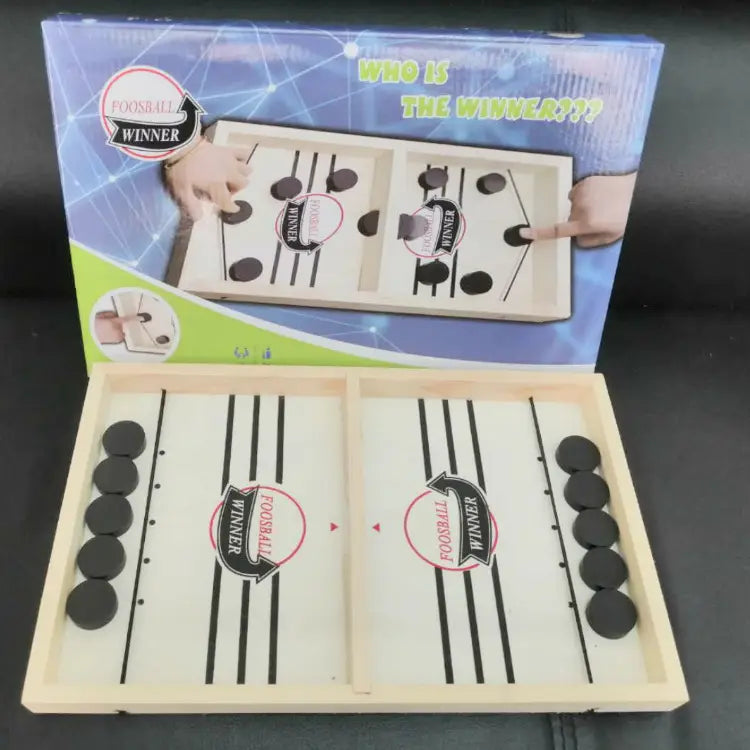 Wooden foosball table game fast sling puck game with black circular pucks and printed foosball winner logos on a light-colored wooden board.