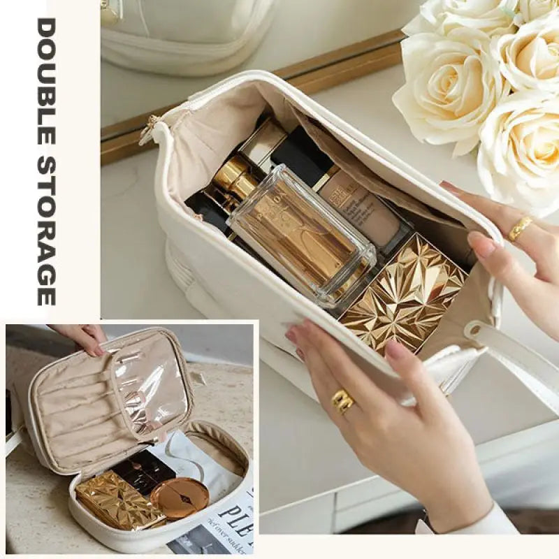 Beige leather large capacity travel makeup bag organizer with double storage compartments and zipper closure holding perfume bottles compact powder and cosmetics.