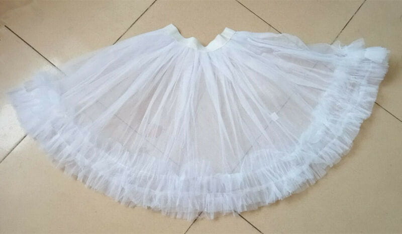 white multi-layered tulle petticoat with a flared ruffled silhouette designed for women’s velvet santa claus christmas party dress