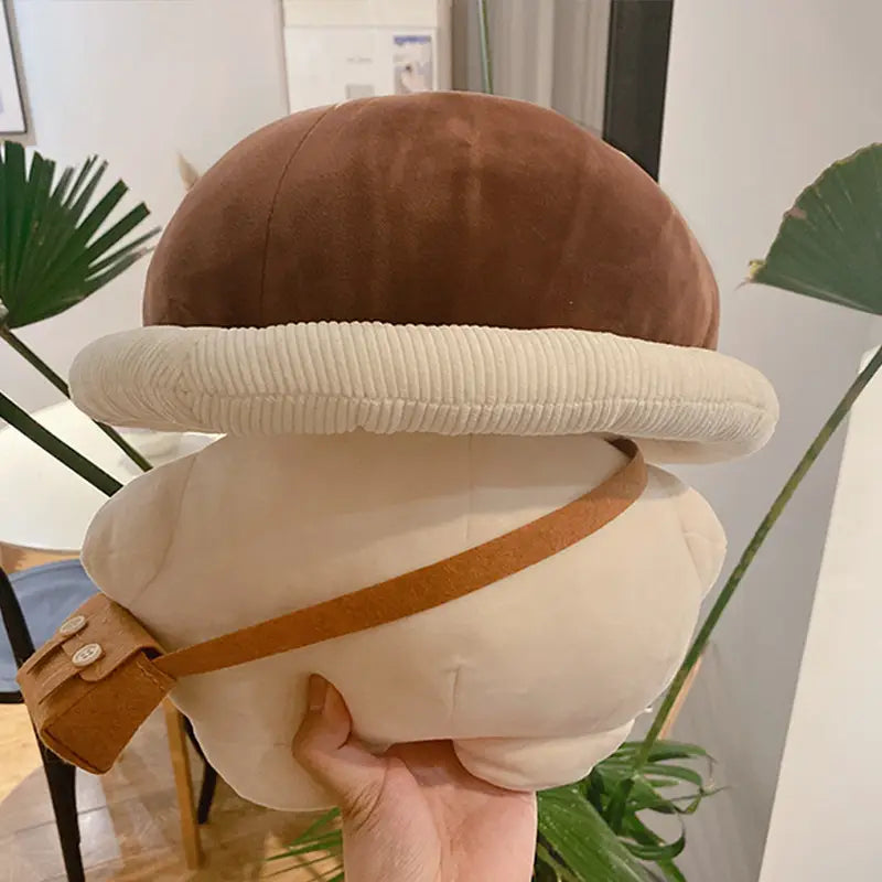 Cute brown and cream mushroom plush pillow featuring a corduroy rim and tan strap shaped like a bread doll toy.