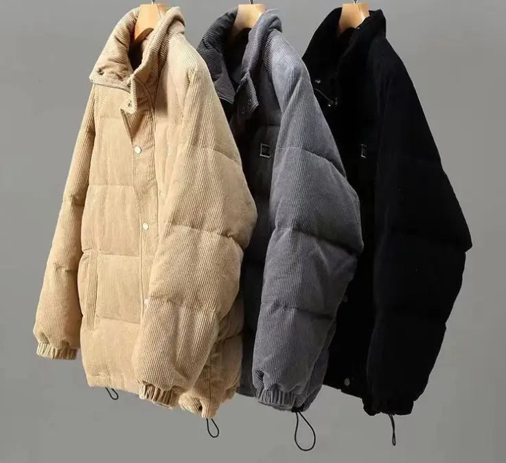 Three corduroy puffer jackets in beige gray and black hang on wooden hangers showcasing mens corduroy puffer jacket retro winter warm coat.