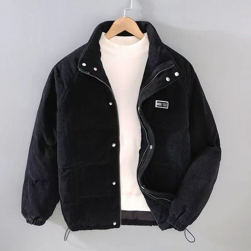 mens corduroy puffer jacket in black features a high collar, silver buttons, and a small rectangular patch on the left chest for retro winter warmth.