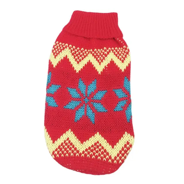 Red knitted dog sweater with blue and cream snowflake and zigzag patterns for festive winter pet apparel.