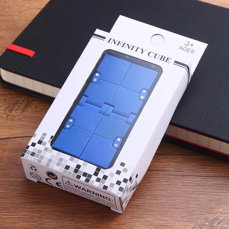 Blue plastic infinity cube fidget toy for stress relief and ADHD in its white and black packaging.