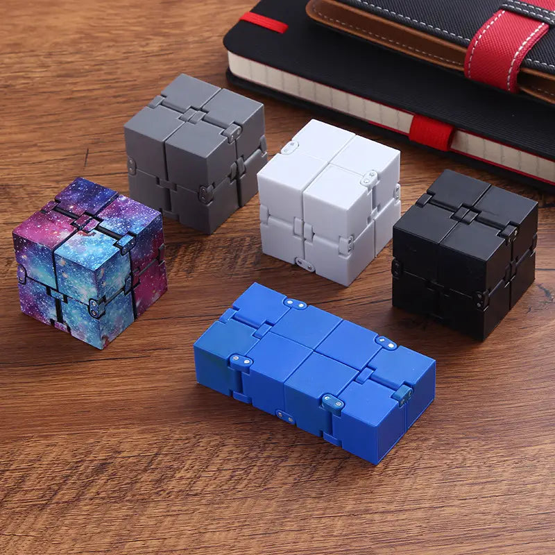 A vibrant galaxy-themed infinity cube fidget toy for stress relief and ADHD with a glossy plastic finish featuring swirling purple and blue nebula patterns.