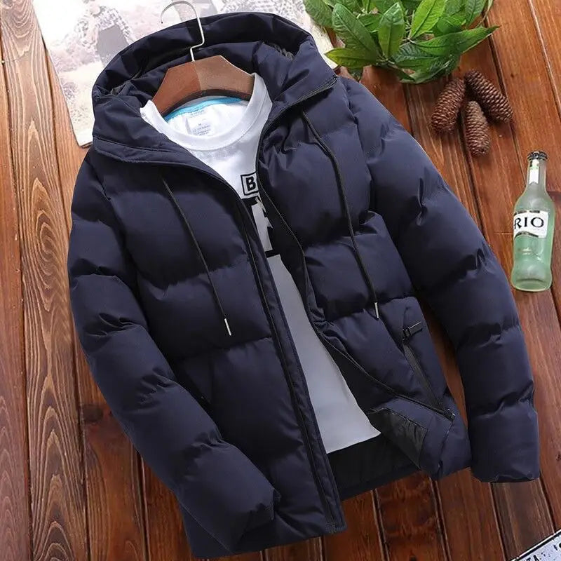 Men’s quilted cotton hooded puffer jacket in dark navy with black drawstrings hanging on a wooden hanger.