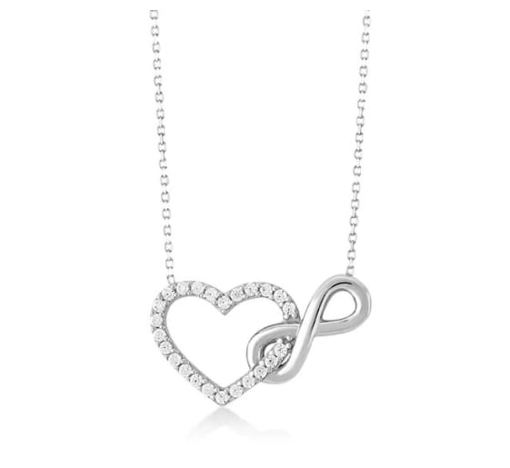 Sterling silver interlocking infinity heart pendant necklace featuring a delicate silver chain with a heart intertwined with an infinity symbol adorned with sparkling diamonds.