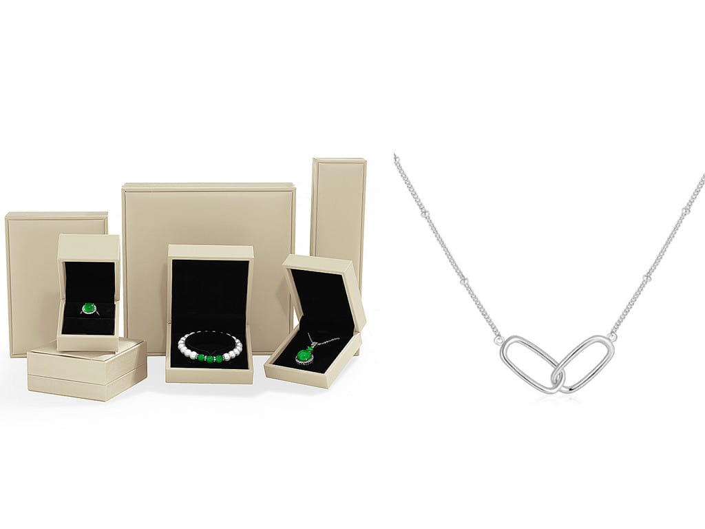 Sterling silver heart shaped pendant necklace with green gemstone and delicate chain.