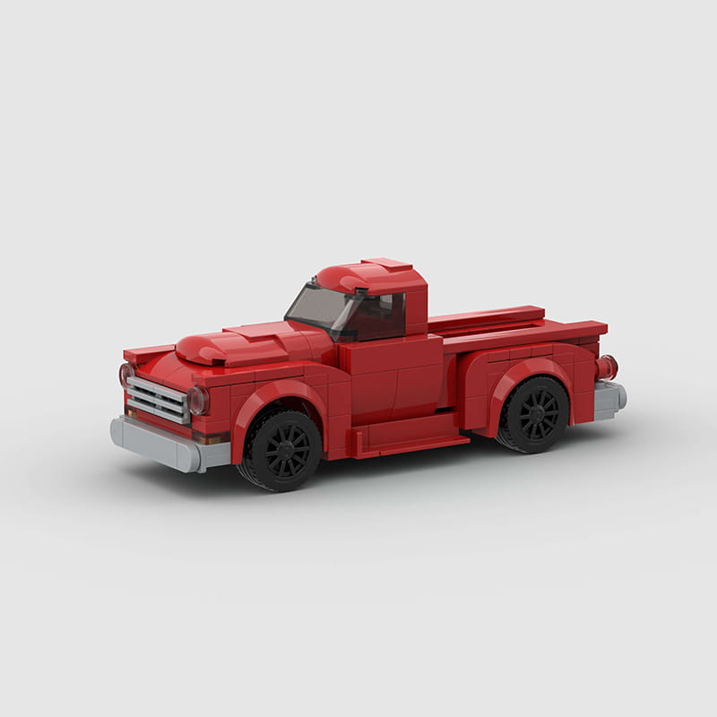 Ensemble de jouets par blocs de construction en forme de camionnette rouge LEGO, avec roues noires et accents argentés.