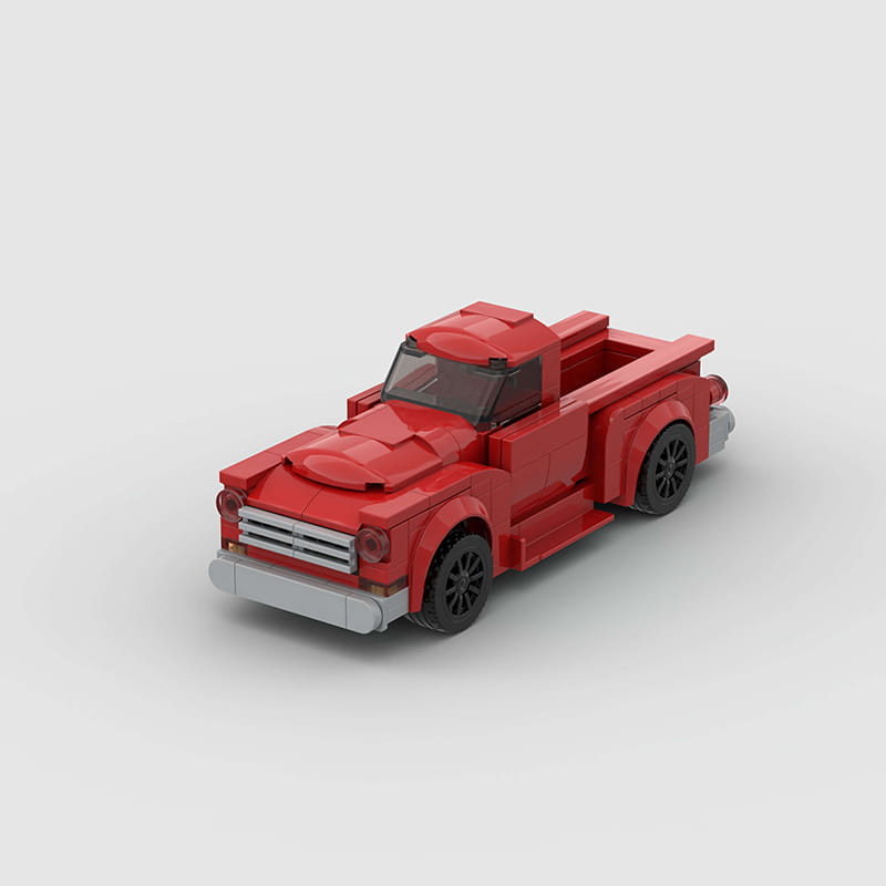 Ensemble de jouets par blocs de construction de camionnette ancienne rouge, avec une camionnette LEGO rouge détaillée, des roues noires et une calandre argentée.