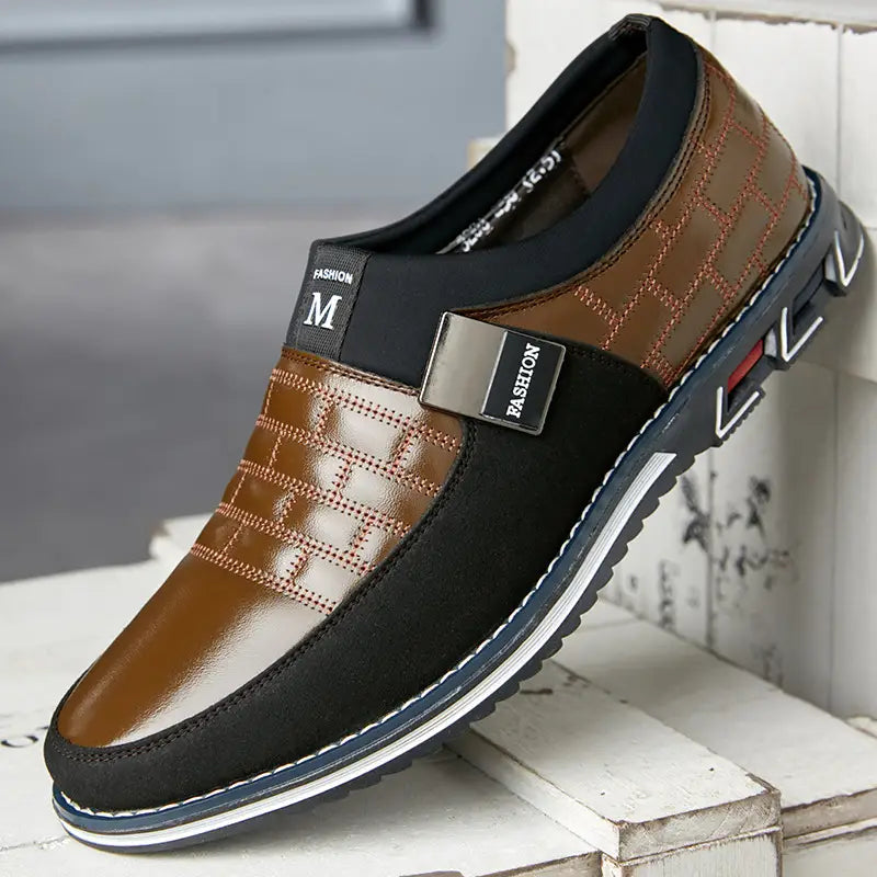 Men’s casual leather slip on shoe in brown and black with quilted pattern stitched detailing and metallic fashion branding on the side designed for large sizes.