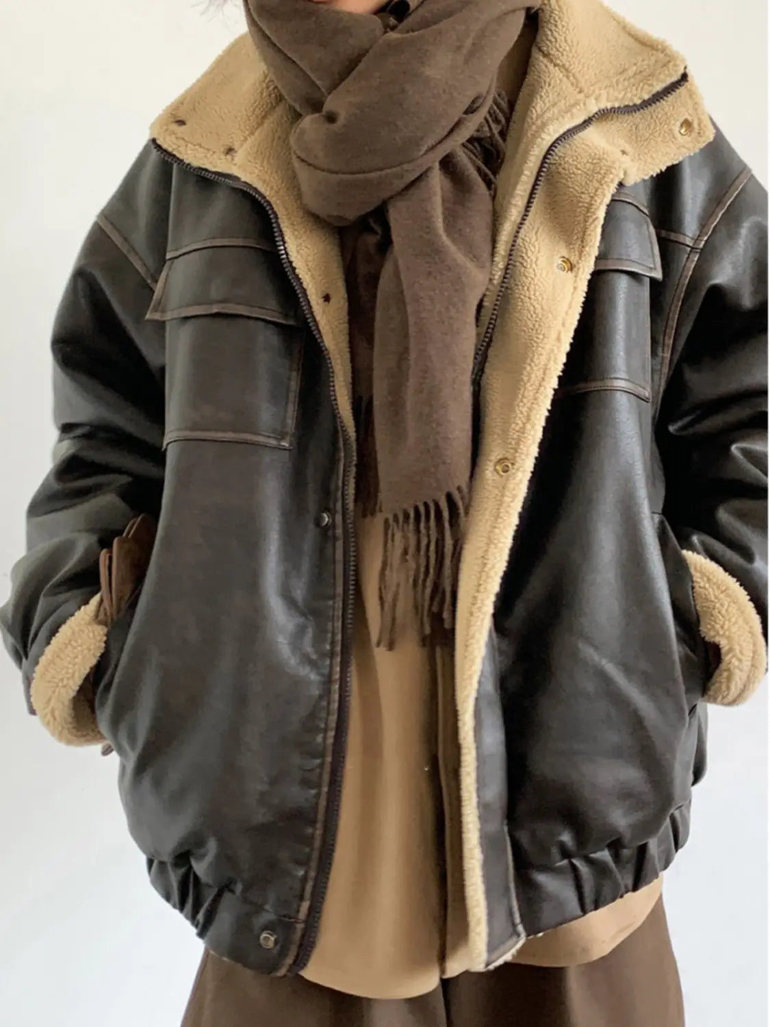 maillard leather bomber jacket with shearling lining in dark brown leather featuring tan shearling lining and cuffs.