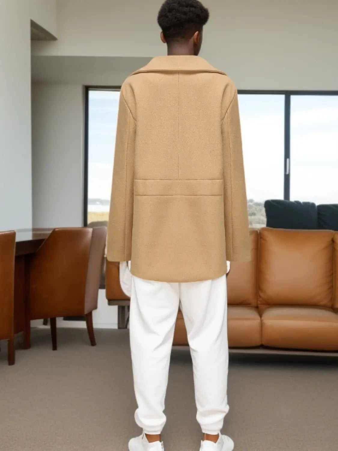 a camel-colored wool blazer with a structured collar and two front pockets shown alongside an olive green wool double-breasted coat