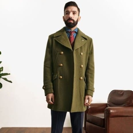 Olive green wool double-breasted overcoat featuring gold-toned buttons in a formal design.