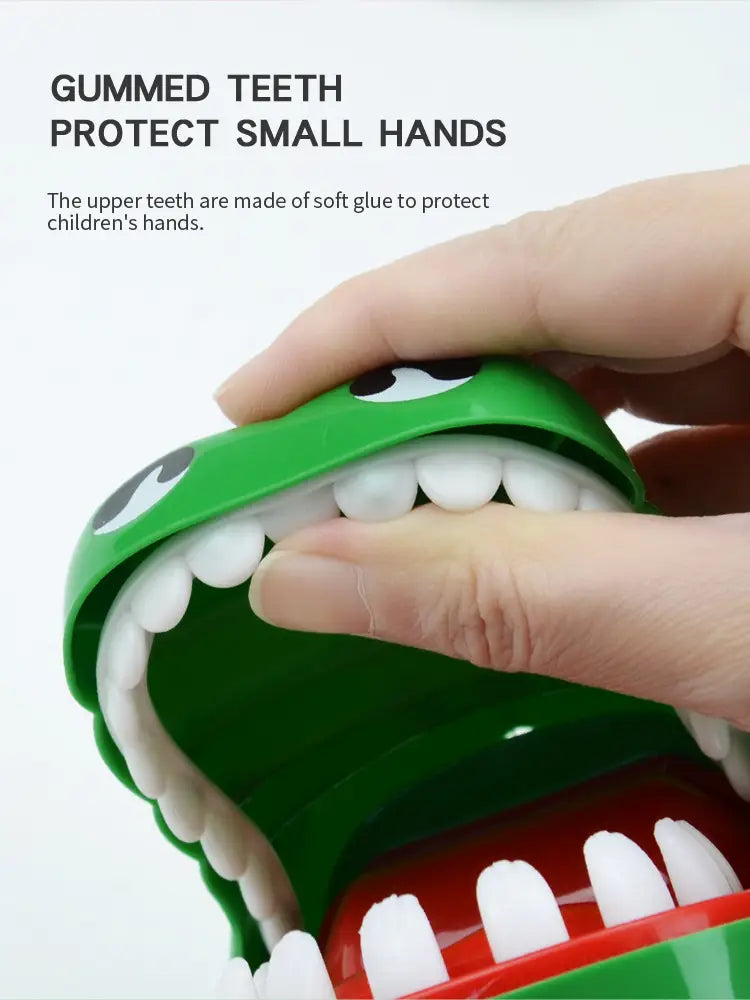green plastic crocodile biting finger game interactive kids toy with white gummed teeth and red interior