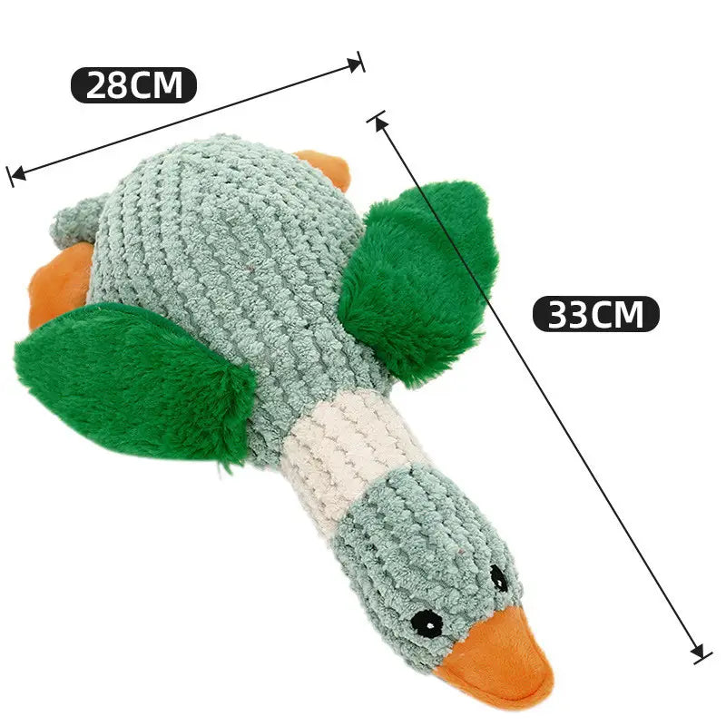 A soft knitted teal duck-shaped plush dog toy with green plush wings and an orange beak designed as a bite resistant molar chew toy.
