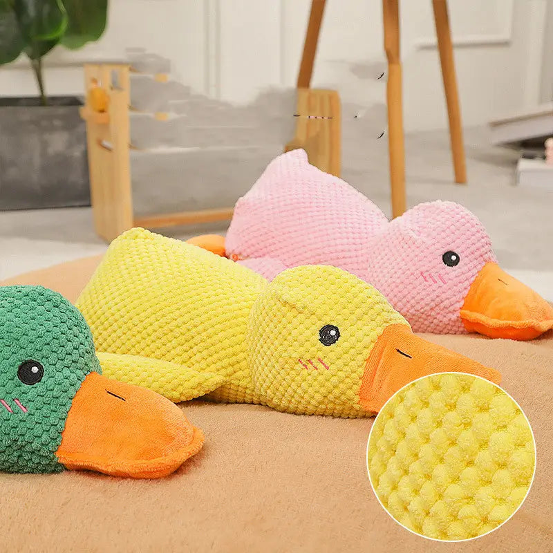 yellow corduroy plush duck dog toy with orange beak and black eyes designed as a bite resistant molar chew toy