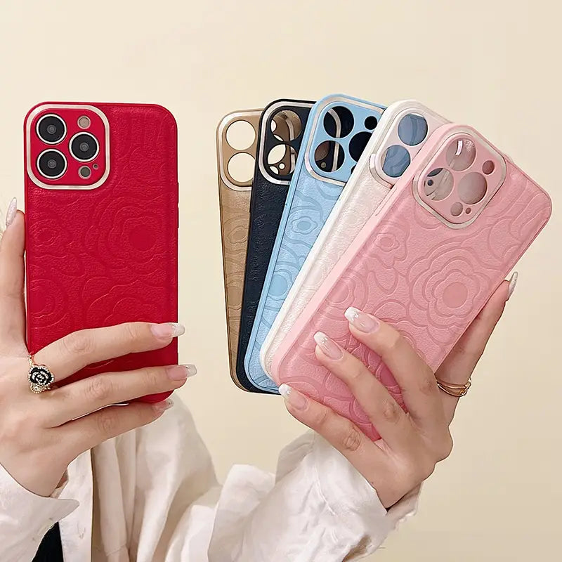 Back side of a red floral-patterned camellia leather phone case for iPhone 11 to 14 with a glossy finish and precise camera cutout.