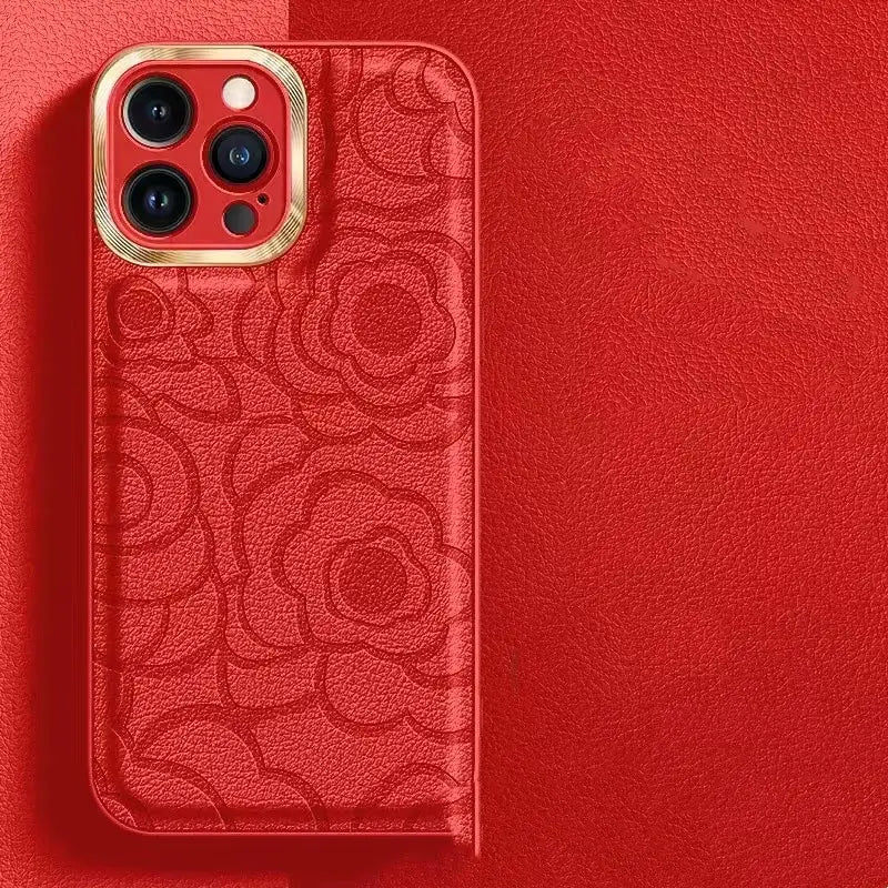 back side of a red floral-patterned leather camellia phone case with a gold-trimmed camera cutout for iphone 11 to 14