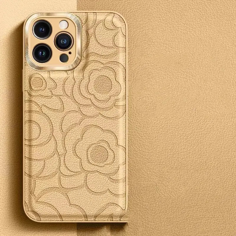 gold-toned leather camellia phone case for iphone 11 to 14 with embossed floral pattern shown from the back side