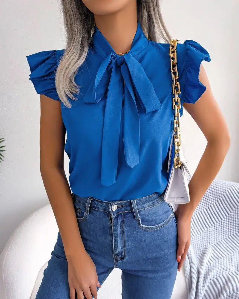 Vibrant blue satin retro ruffled bowknot short sleeve blouse with ruffled sleeves and a prominent bow at the neckline.