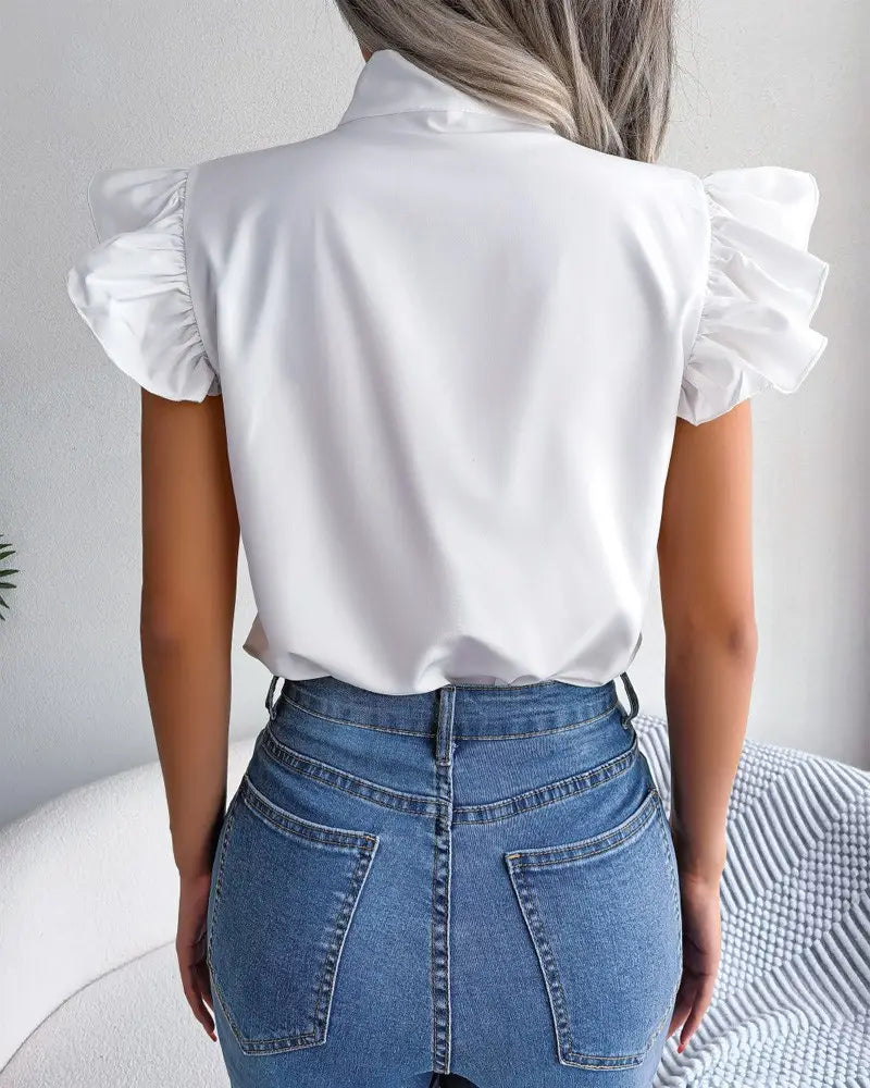 White blouse with ruffled short sleeves and a collar featuring a retro bowknot design suitable for formal or casual wear.