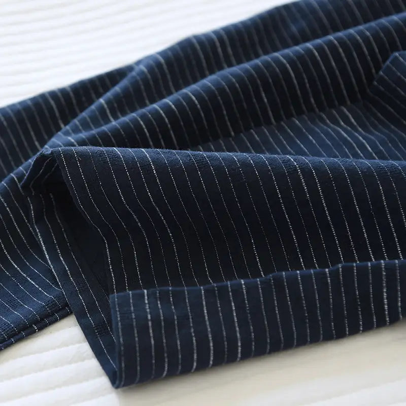 Dark blue striped cotton kimono pajama set for men featuring fine white pinstripes and a soft textured weave.