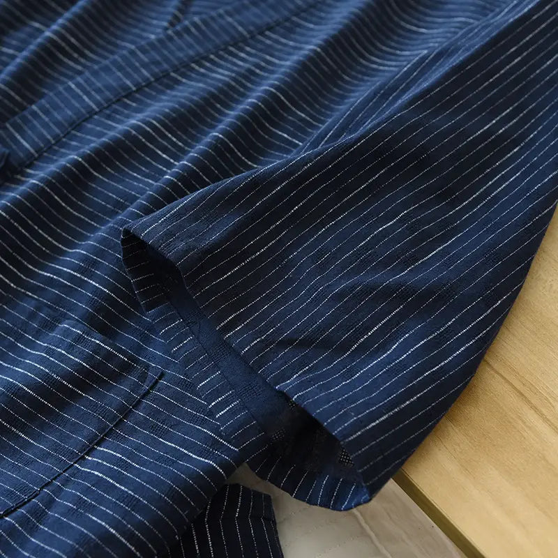 deep navy blue striped cotton kimono pajama set for men with fine white pinstripes and soft textured weave featuring a neatly finished sleeve cuff