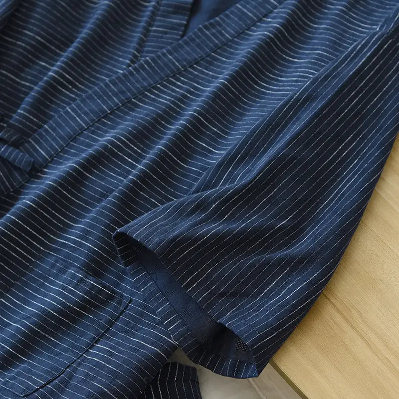 A navy blue cotton kimono pajama set for men featuring fine white pinstripes and a traditional Japanese design.