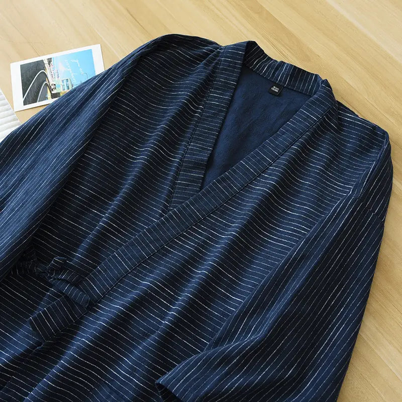 A navy blue striped cotton kimono pajama set for men featuring fine white pinstripes and a soft textured fabric.