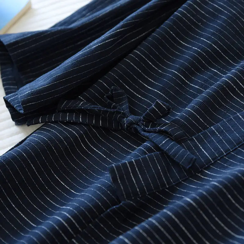 Dark blue linen robe with fine white pinstripes and a traditional tied closure from the striped cotton kimono pajama set for men.
